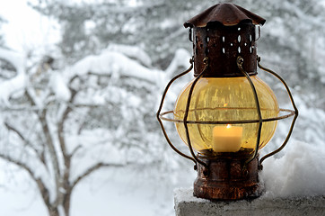 Image showing vintage lantern against the winter garden