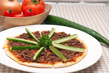 Image showing Turkish beef pizza with cucumber on top