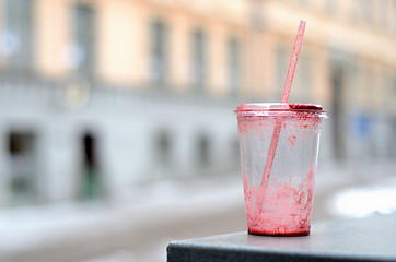 Image showing empty dirty plastic cup and cocktail straw outdoor