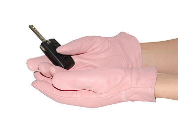 Image showing Car key in female hands in pink gloves