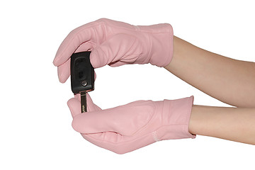 Image showing Auto key in elegant pink gloves