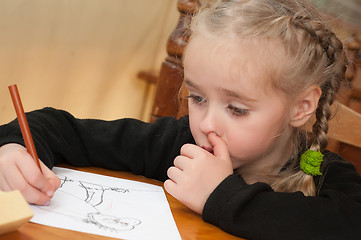 Image showing Little girl is drawing