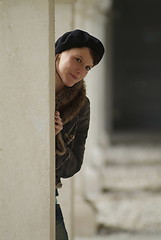 Image showing young woman leans at a pillar