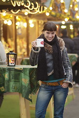 Image showing young woman drinks glogg
