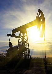 Image showing working oil pump at sunset