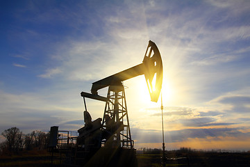 Image showing working oil pump at sunset