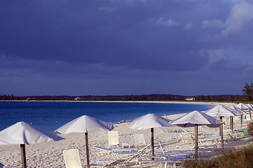 Image showing ocean beach with chairs umbrellas