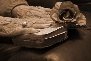 Image showing Senior hands on a bible