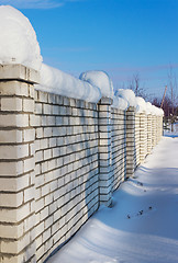 Image showing Brick wall, covered with snow in January
