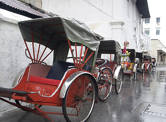 Image showing Trishaws waiting in the rain