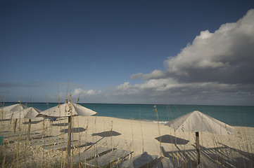 Image showing ocean beach with chairs umbrellas