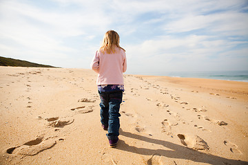 Image showing Young girl walking on beach