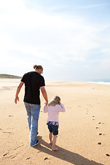 Image showing Father and daughter walking at the beach