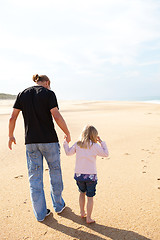 Image showing Father and daughter walking at the beach