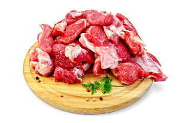 Image showing Meat cut into slices on a round board