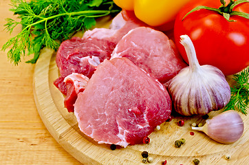 Image showing Meat slices on a wooden board with vegetables