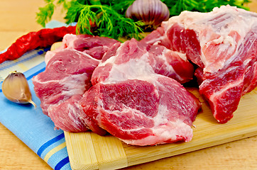 Image showing Meat on a wooden board with vegetables