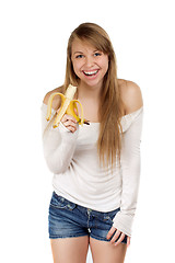 Image showing Smiling woman holding banana  