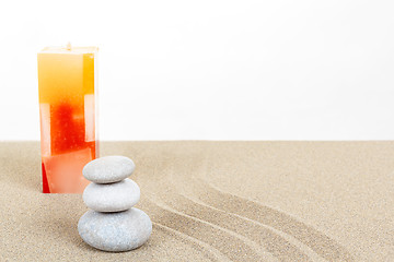 Image showing Balance zen stones and candle in sand on white