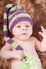 Image showing Newborn baby in long striped hat