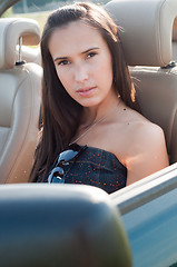 Image showing Beautiful brunette woman sitting in the car