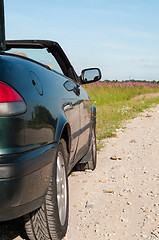 Image showing Dark green cabrio on the road