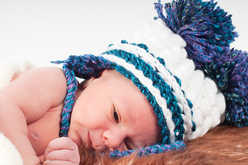 Image showing Newborn baby in knitted hat with pom-pons