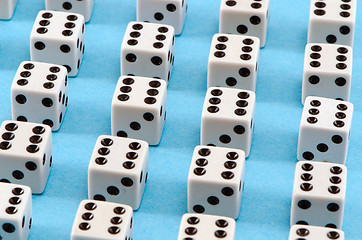 Image showing white gamble dice black dots blue background 