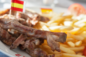 Image showing French fries and ribs