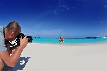 Image showing photographer taking photo on beach