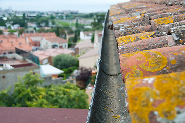 Image showing Rain gutter on the old tile roof