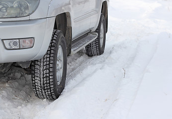 Image showing Snowy winter road ahead an unrecognizable car