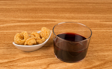 Image showing Wine and pork rinds