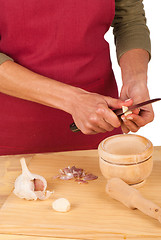 Image showing Chopping garlic