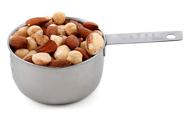 Image showing Mixed nuts presented in an American metal cup measure