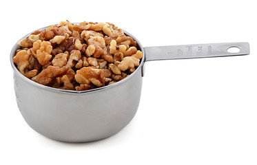 Image showing Chopped walnuts presented in an American metal cup measure