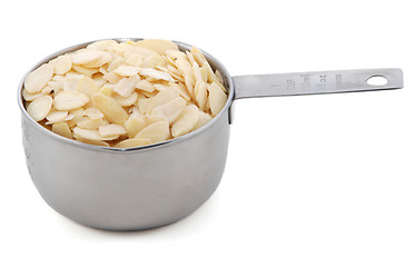 Image showing Flaked almonds presented in an American metal cup measure