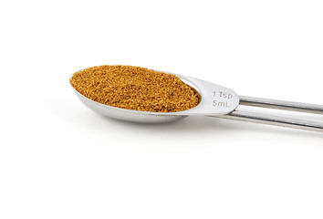 Image showing Curry powder measured in a metal teaspoon