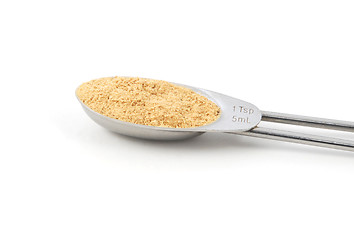 Image showing Ground ginger measured in a metal teaspoon