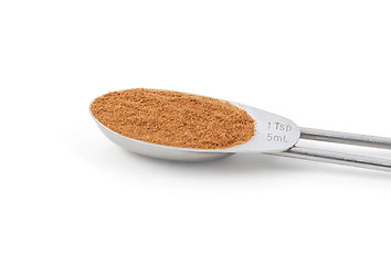 Image showing Ground cinnamon measured in a metal teaspoon