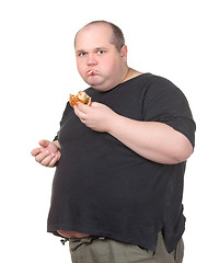 Image showing Fat Man Greedily Eating Hamburger
