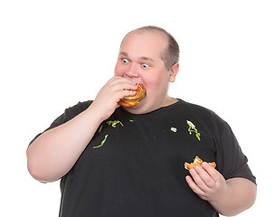 Image showing Fat Man Greedily Eating Hamburger