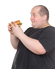 Image showing Fat Man Looks Lustfully at a Burger