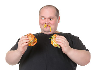 Image showing Fat Man Looks Lustfully at a Burger