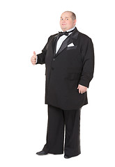 Image showing Elegant fat man in a tuxedo shows thumb-up