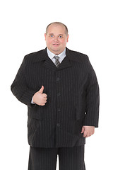 Image showing Elegant fat man in a black suit shows thumb-up