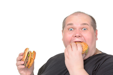 Image showing Fat Man Greedily Eating Hamburger