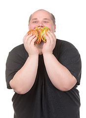 Image showing Fat Man Looks Lustfully at a Burger