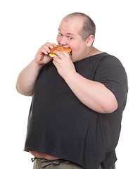 Image showing Fat Man Greedily Eating Hamburger