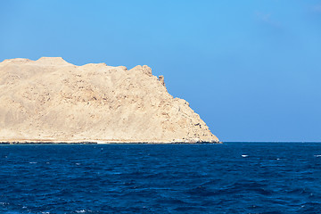 Image showing Sea with stony bare mountain in the background